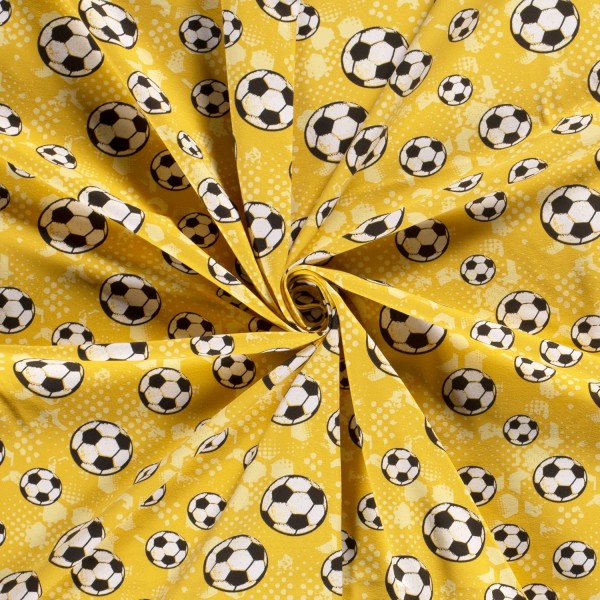 Baumwolljersey ocker mit Fußballmuster – Kinderstoff & Bekleidungsstoff